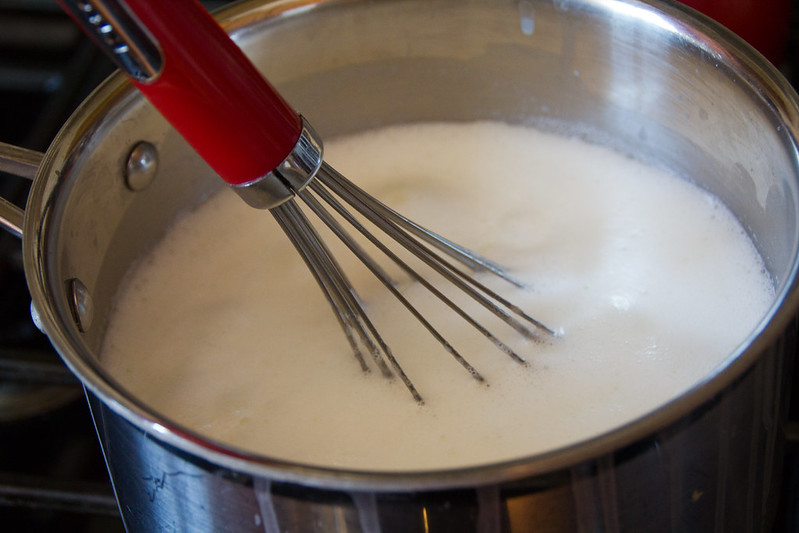 Whisking ingredients for tapioca pudding in a saucepan